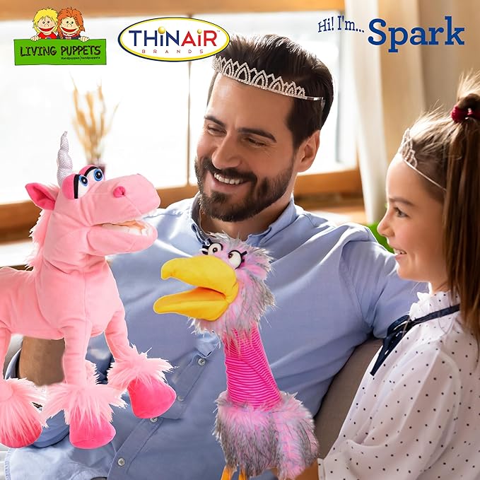 A man and a child share a moment, both adorned with tiaras, as they play with colorful puppet toys—a whimsical pink unicorn hand puppet and a quirky pink bird. Logos and text for "Living Puppets" and "Spark" highlight the joy of toys &amp; games in child development.