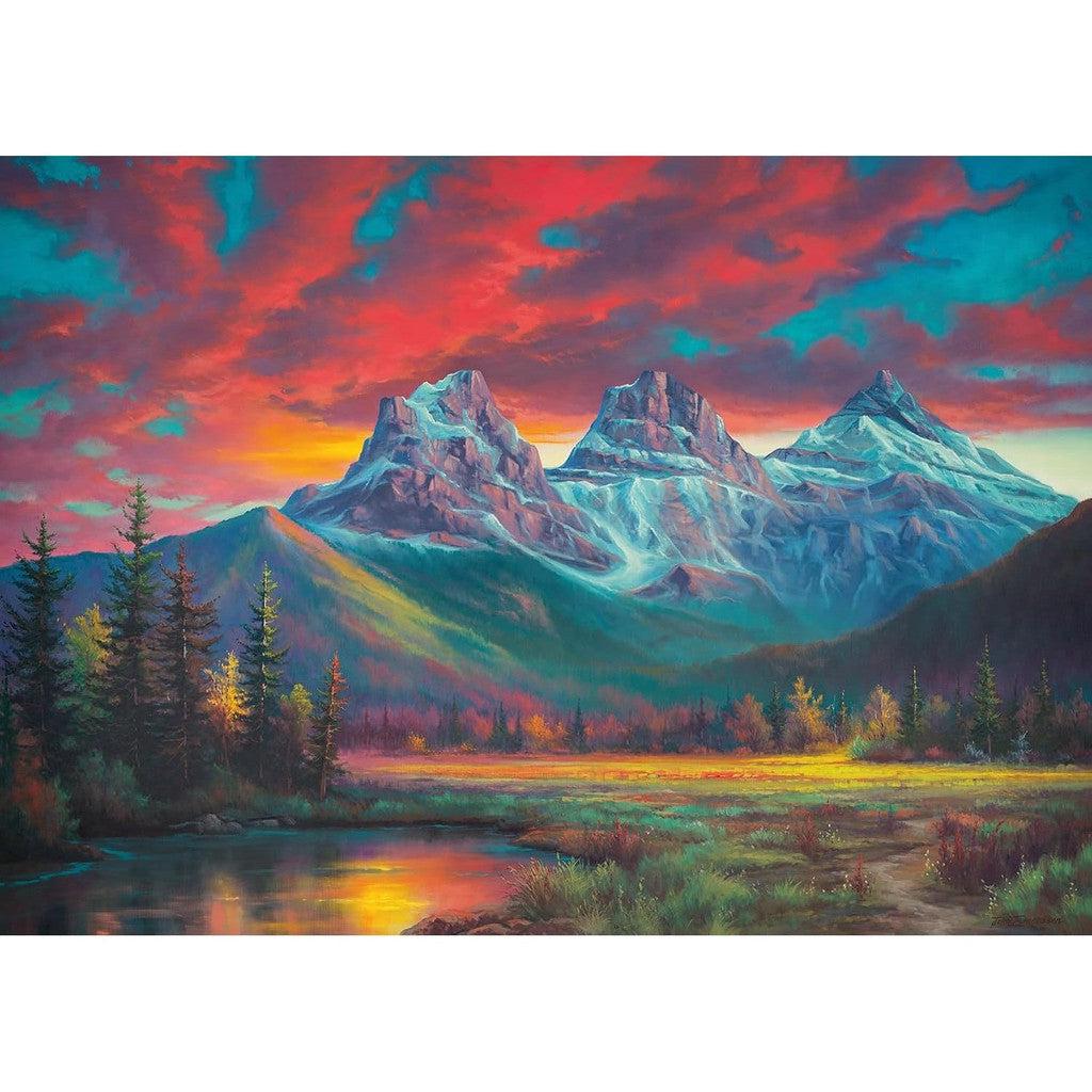 This vibrant 1000-piece jigsaw puzzle captures a colorful painting of a mountain landscape at sunset, featuring three snow-capped peaks, a lush green forest, and a reflective lake in the foreground, reminiscent of Ravensburger's exquisite craftsmanship.