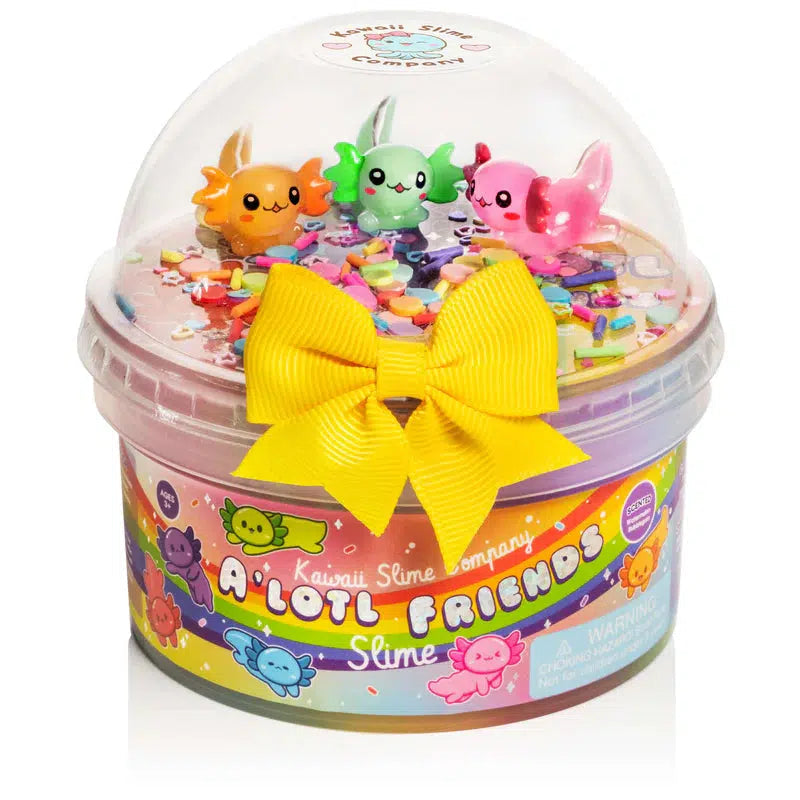 Axolotl Friends slime from Kawaii Slime company. Three colorful axolotls sit in a dome on top of a rainbow tub of slime.