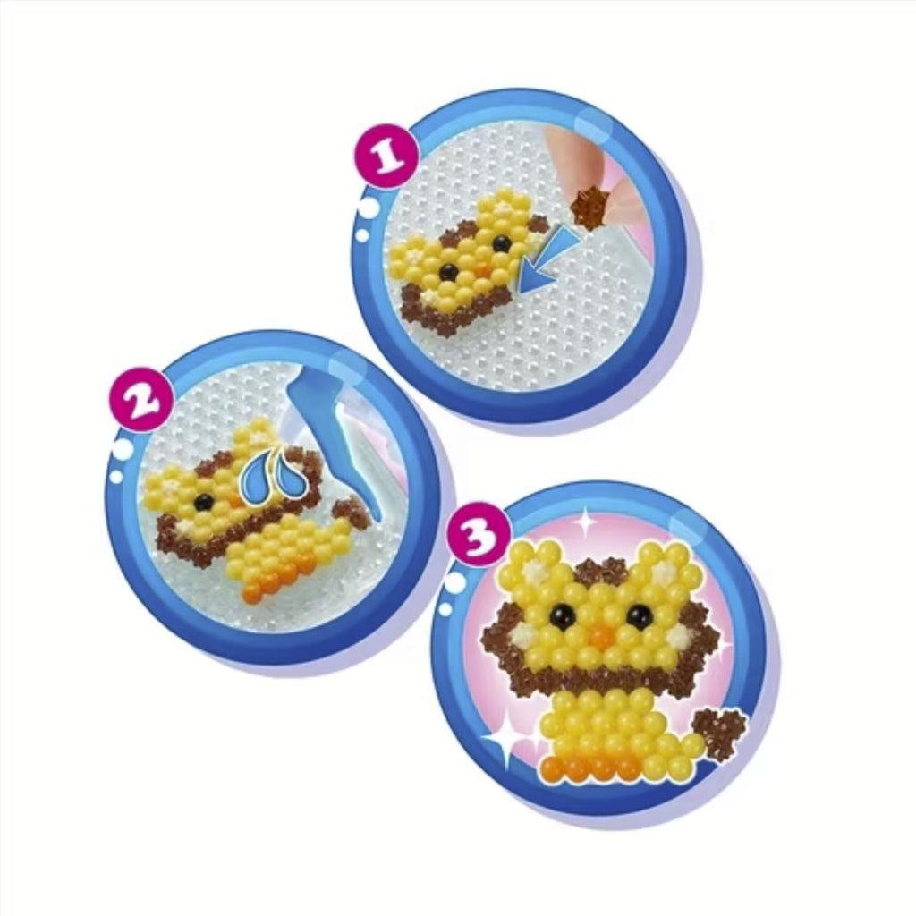 Shows how to create the aquabeads creatures. 1) Arrange the beads 2) Spray with water 3) Done!