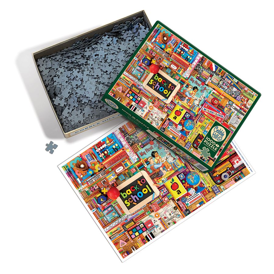 Open puzzle box with pieces and poster