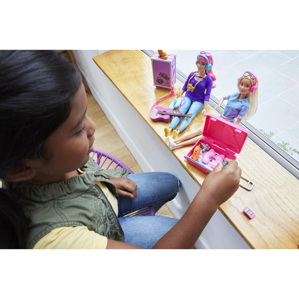 Scene of a little girl packing Barbie's travel bags.