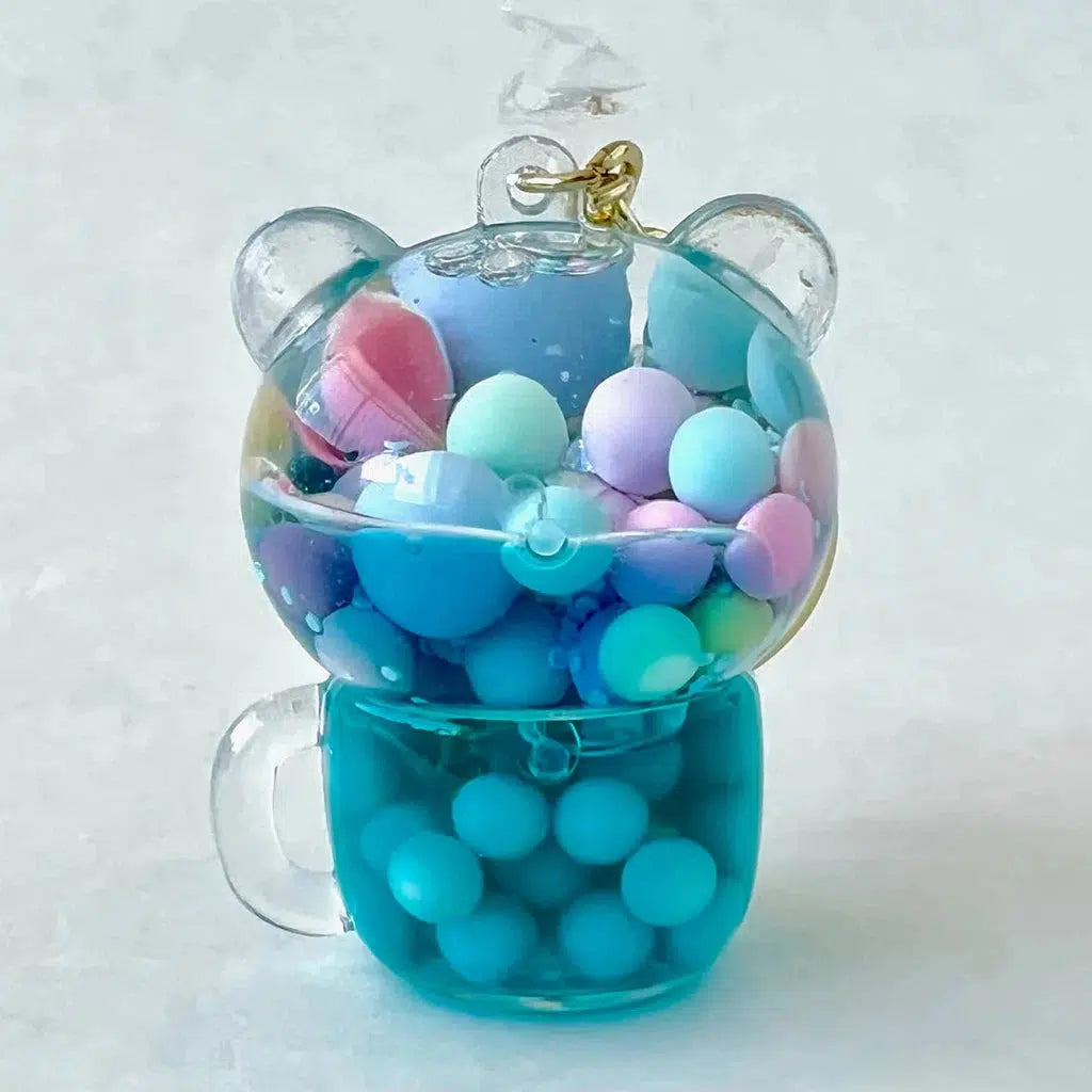 A clear bear-shaped container filled with colorful pastel beads and a blue liquid base, perfect for those who adore silly animals and assorted designs.