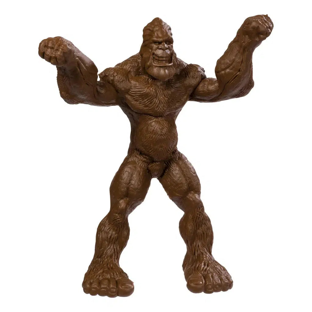 A brown Bigfoot toy figurine stands with arms raised, featuring bendable limbs for dynamic poses.