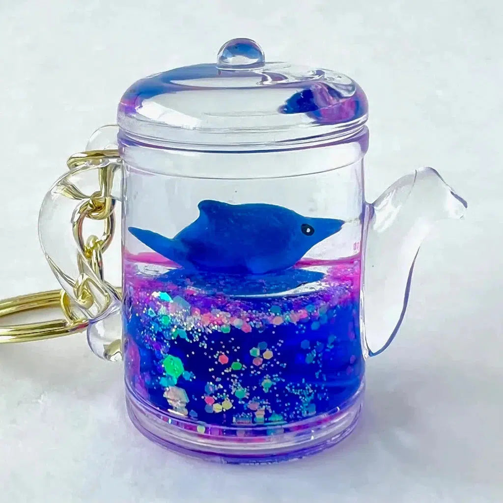 teapot keychain with blue dolphin inside
