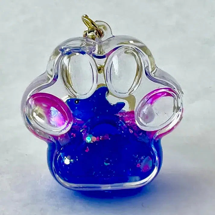 paw keychain with blue dolphin inside