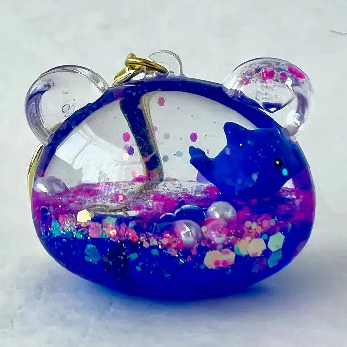 bear keychain with blue dolphin inside