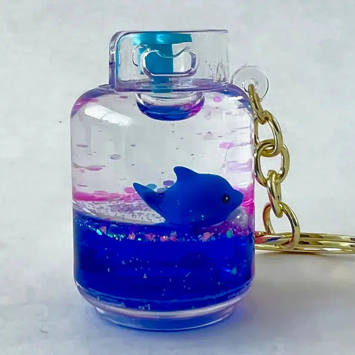 Bottle shaped keychain with blue dol[phin inside