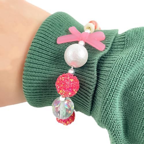 Close-up of a wrist adorned with a bracelet featuring a pink bow and colorful DJECO Silver Bubble Beads over a green sweater sleeve, showcasing the charm of Sparkling Jewelry Creations.