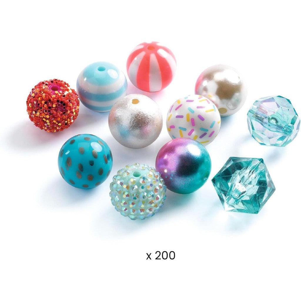 A variety of colorful, patterned beads, including DJECO Silver Bubble Beads, are arranged together with round and faceted shapes for engaging educational art crafts.