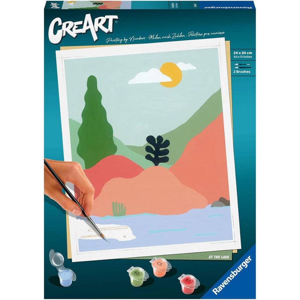 Box of CreArt painting of desert landscape behind a lake