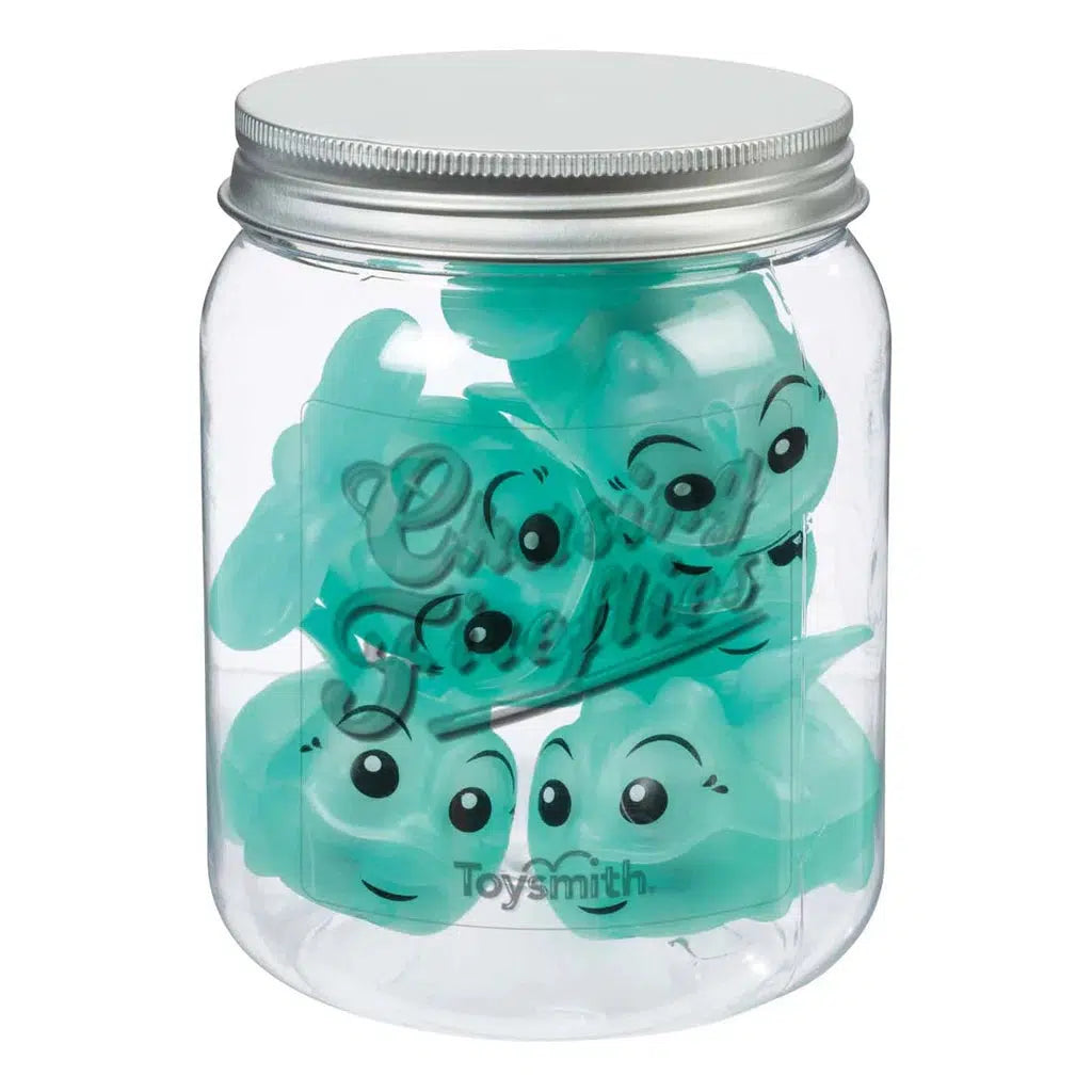 A clear jar with a metal lid contains several blue rubber toys shaped like smiling cartoonish animals, perfect for indoor and outdoor play. These delightful companions could be the stars of a Chasing Fireflies game, adding excitement and laughter to your child's adventures.