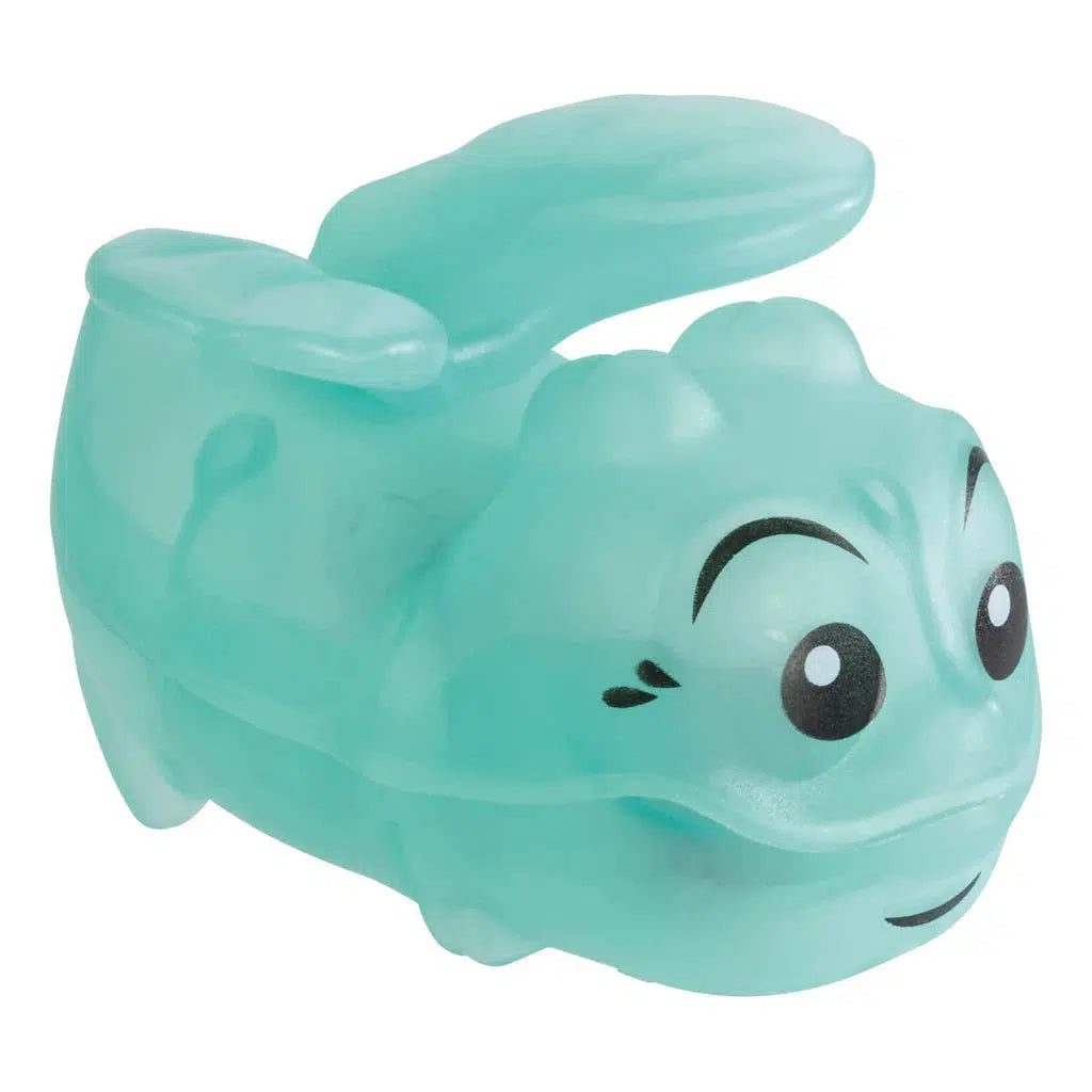 A small, translucent, blue-green plastic toy with cartoonish facial features and two raised flaps resembling ears or wings, perfect for indoor play.