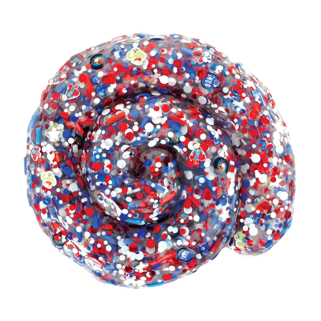 Closeup of comic book putty. Red white and blue glitter or sprinkles with tiny super heroes and signs.