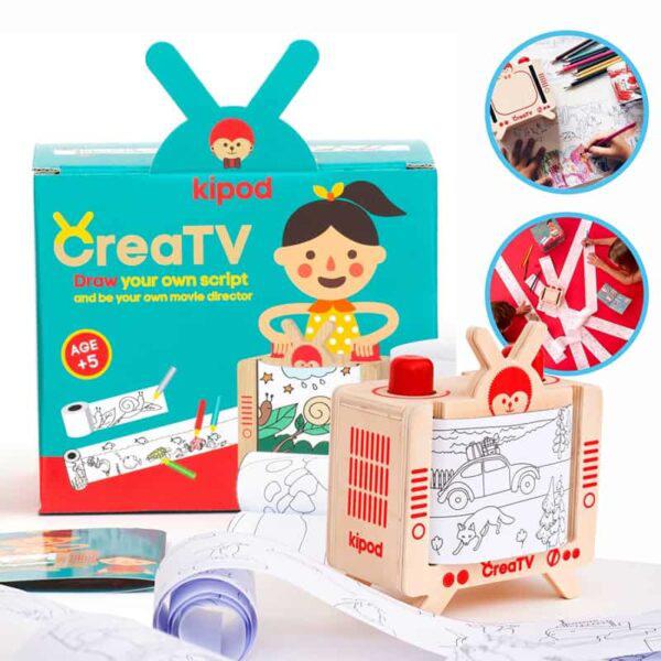 The image shows a children’s drawing kit labeled "CreaTV" by Kipod. This kit includes a box, a wooden frame resembling a TV, drawing sheets, and rolled paper, perfect for playtime.