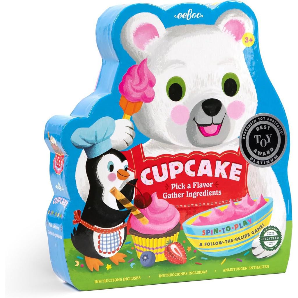 Packaging for "Cupcake," an animal and baking themed game for preschoolers, features a friendly bear and penguin with cupcakes. The interactive fun includes a cupcake-shaped spinner, promising sweet adventures in every play.