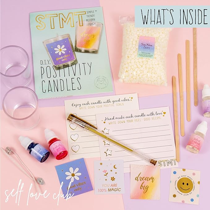 Overview of what is inside DIY candle kit. Glasses, dye, paper, pens, soy wax, stickers