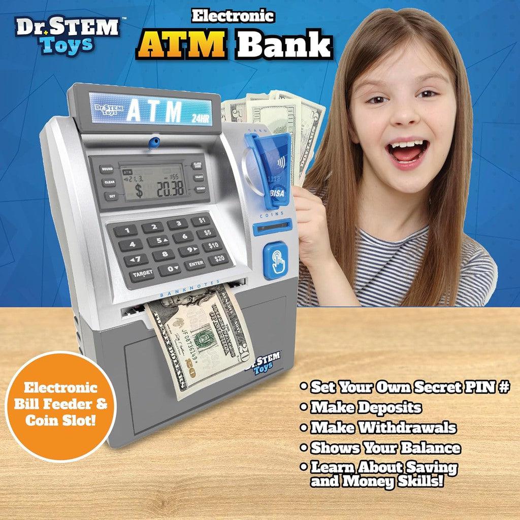 Child smiling next to a toy Kids ATM Savings Bank. The electronic piggy bank features a keypad, screen, bill feeder, and coin slot. Text highlights features such as setting a PIN, making deposits, and withdrawals—making it an ideal STEM toy for young learners.