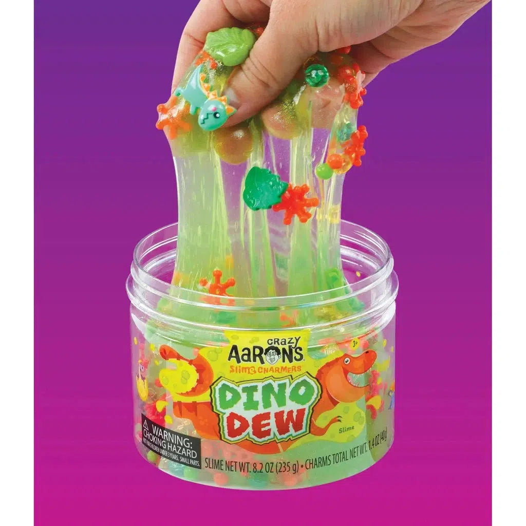 Hand playing with charm-filled slime