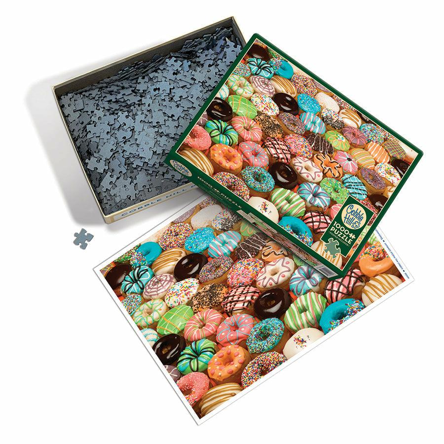 an overhead of the box of pieces and an image of the completed puzzle