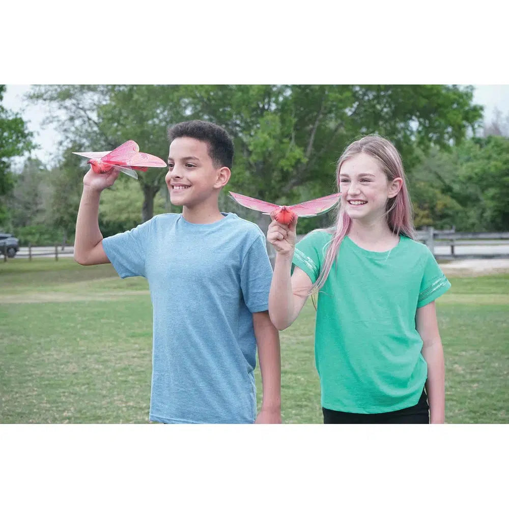 Scene of two kids playing with the outdoor flying toys.