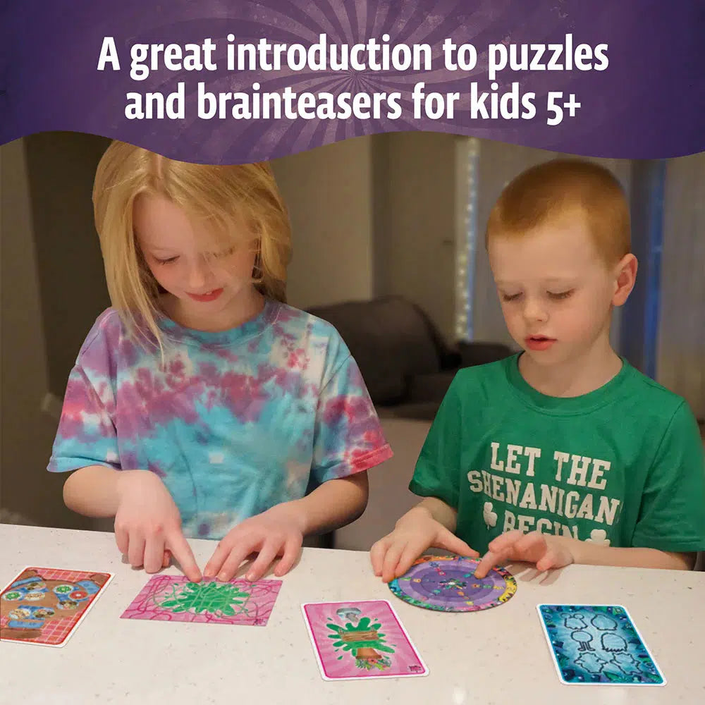 Two children are standing at a table, mesmerized by colorful puzzle cards from the Monsterville collection. The text above them reads, "A great introduction to puzzles and brainteasers for kids 5+.