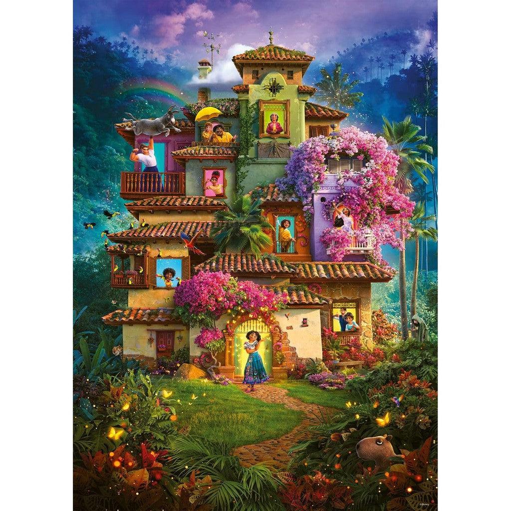 This colorful, multi-story house adorned with flowers and surrounded by lush greenery looks like it's straight out of a Disney Encanto scene. With people at various windows and a scenic mountain backdrop, it’s the perfect image for Ravensburger jigsaw puzzles.