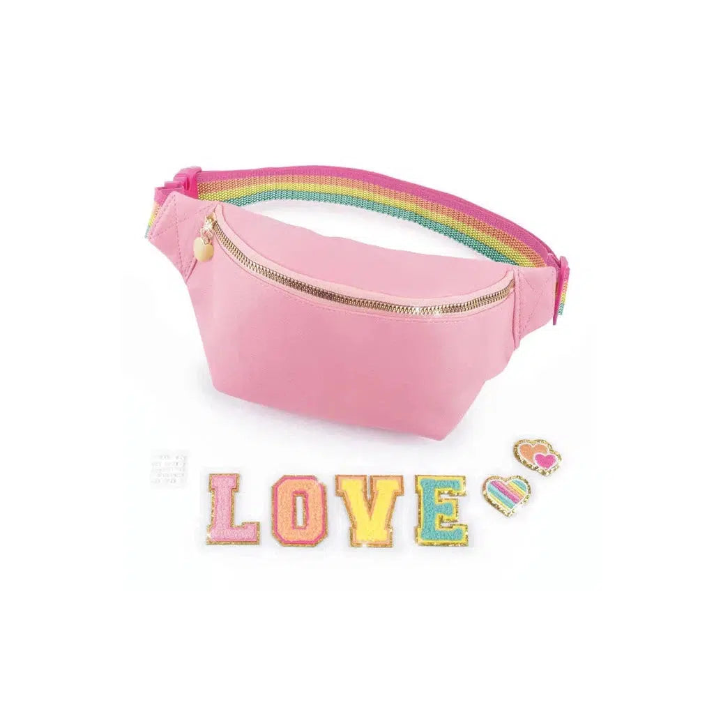 A pink bum bag with a vibrant rainbow strap is displayed. Below it, colorful decorative letters spell "LOVE," accompanied by two heart-shaped patches, perfect for DIY fashion lovers.