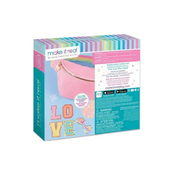 The DIY craft kit includes a pink pouch made of sparkly terry fabric and decorative items, with the word "LOVE" prominently displayed. The brand "Make It Real" graces the top, and you can personalize your design with fashionable love patches.