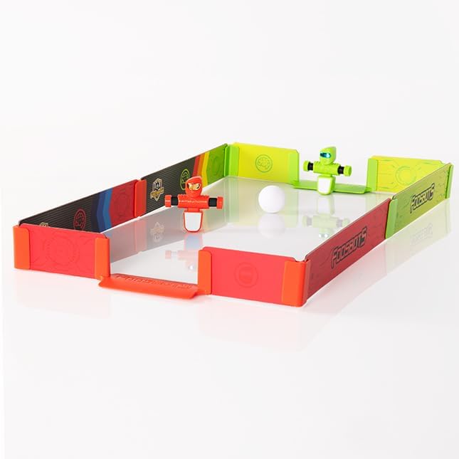 In the Foosbots Stadium Battle Set, two toy robots, one red and one green, face off in a miniature arena with a small white ball in the center. This exciting Fat Brain Toys creation promises hours of active play for kids and adults alike.