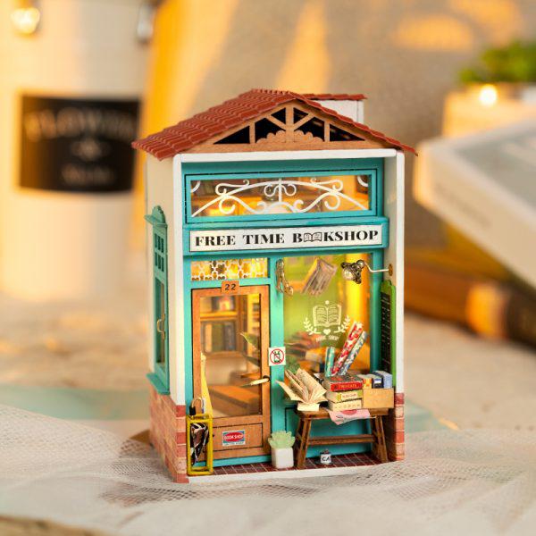 Tiny model of a store named Free Time Bookshop. Various tiny books and goods are spread about the model