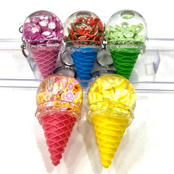 Five colorful ice cream cone key charms with transparent tops displaying decorative fruit slices, housed in pink, blue, green, red, and yellow cones. Perfect for adding a whimsical touch to your collection or jazzing up a set of keys.