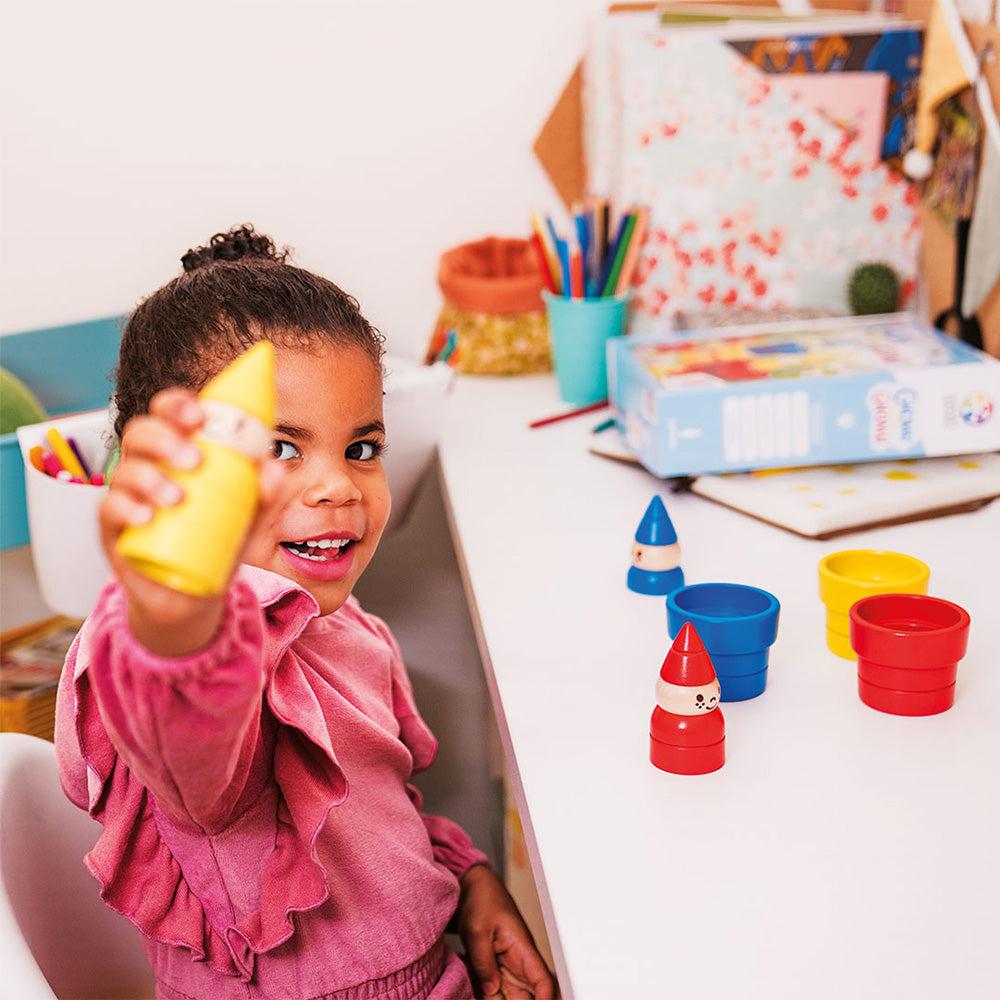 Child playing with gnome game piece
