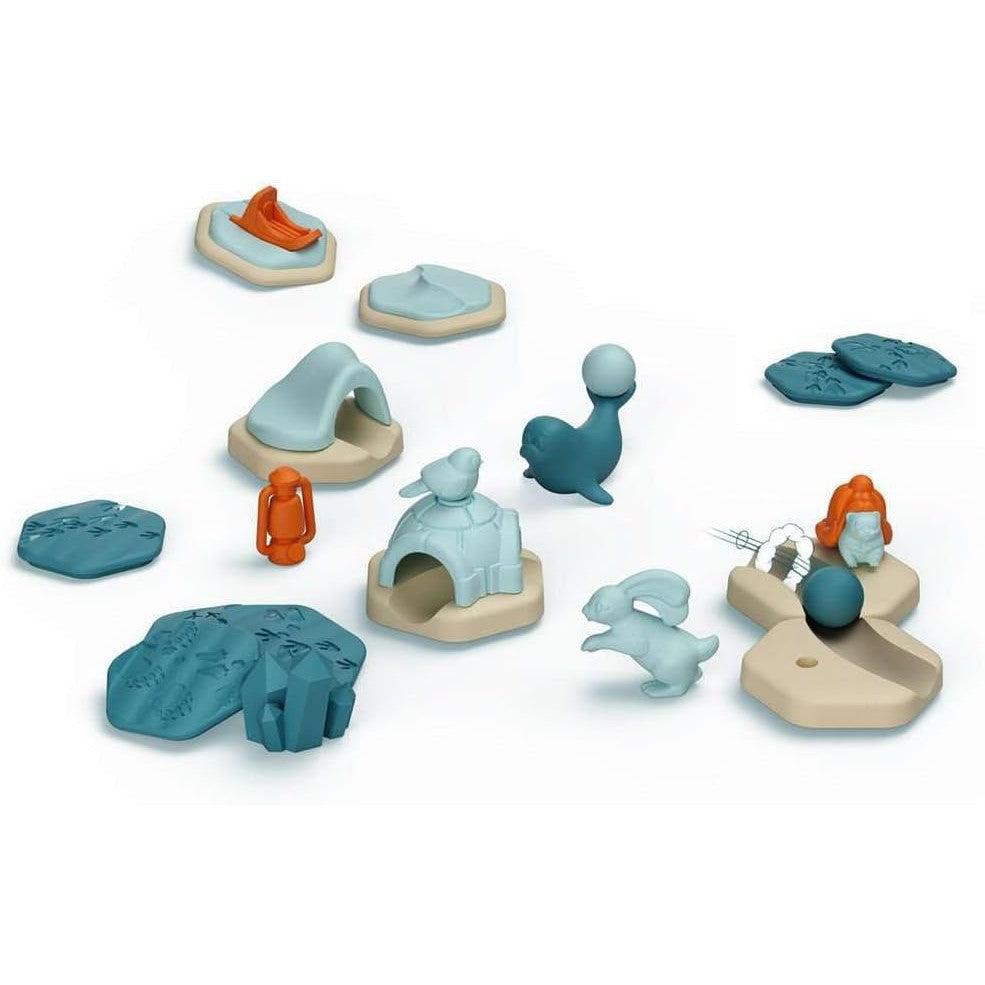 Explore a captivating collection of plastic toys, including animals, a figure, and various terrain pieces in shades of blue, beige, and orange. These vibrant STEM toys inspire creativity and learning through play.