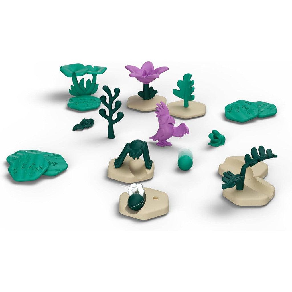 A collection of small plastic plant toys and a purple bird figurine arranged on hexagonal bases, reminiscent of the STEM Toys aesthetic.