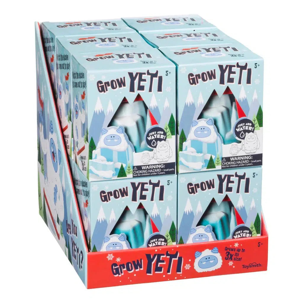 Display of "Hatchin’ Grow Yeti" toy boxes with blue yeti illustrations and mountains on the packaging. This DIY grow toy is suitable for ages 5 and up.