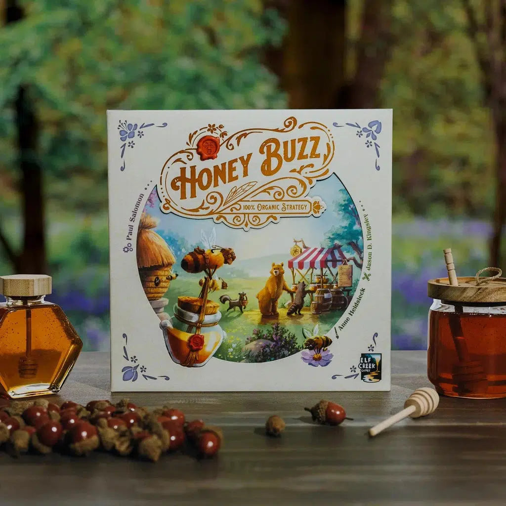 The board game Honey Buzz on an outdoor table surrounded by honey jars and acorns. The box features woodland creatures waiting to buy honey from the bees.