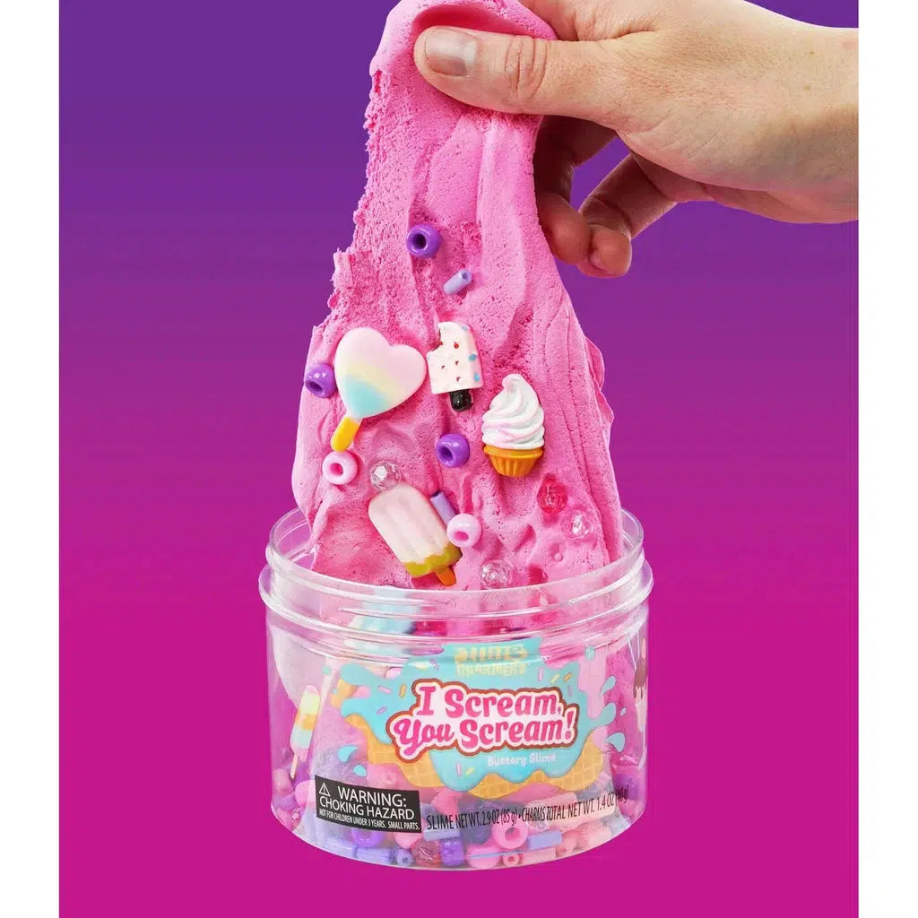 hand stretching slime with charms in it