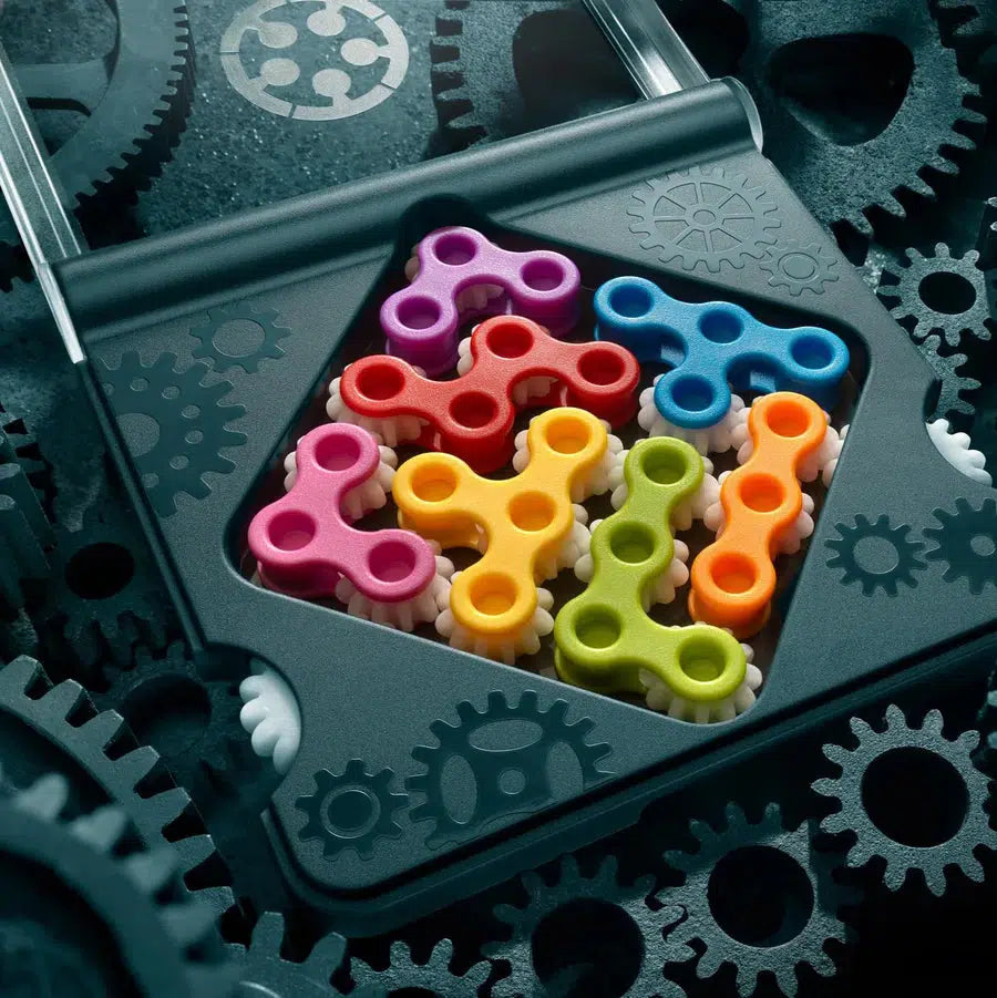 Colorful plastic gears arranged in a black, gear-themed tray surrounded by larger black gears, this travel-friendly set doubles as a brain game designed to stimulate your mind on the go.