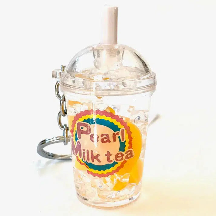 Key charm shaped like a fruit pearl milk tea cup with a straw, clear liquid, and colorful logo. Perfect for adding a touch of whimsy to your set of keys, this delightful accessory celebrates the fun, playful spirit of boba culture.