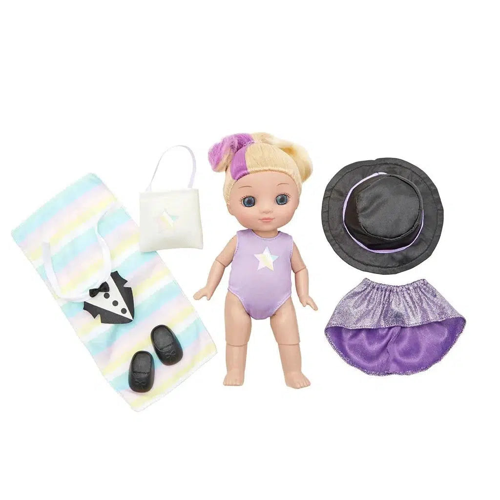 A doll in a star-themed outfit, ready to dance or swim, surrounded by accessories like a towel, bag, shoes, hat, and skirt.