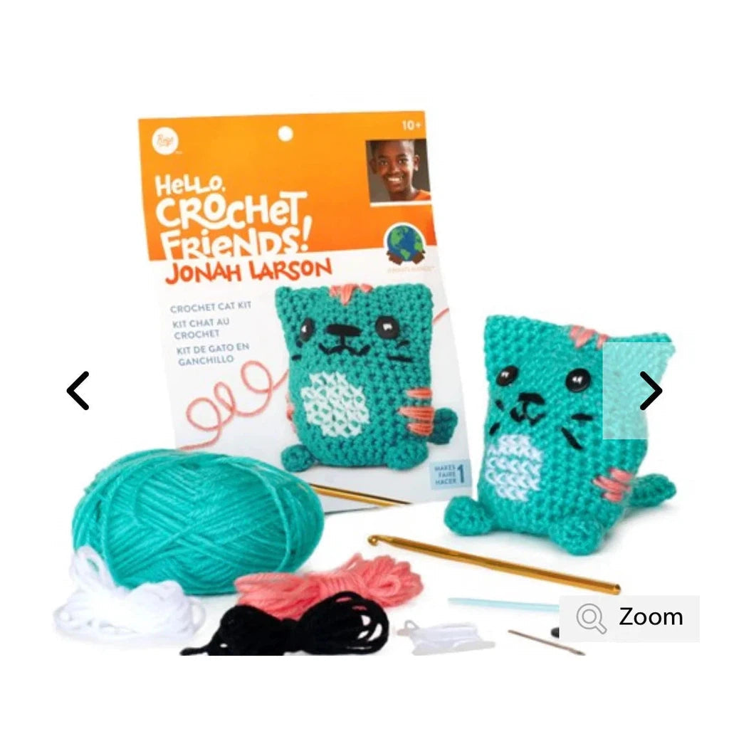 A crochet kit of a blue cat with all of the needed components. A ball of blue yarn with smaller amounts of pink, white, and black yarn. 