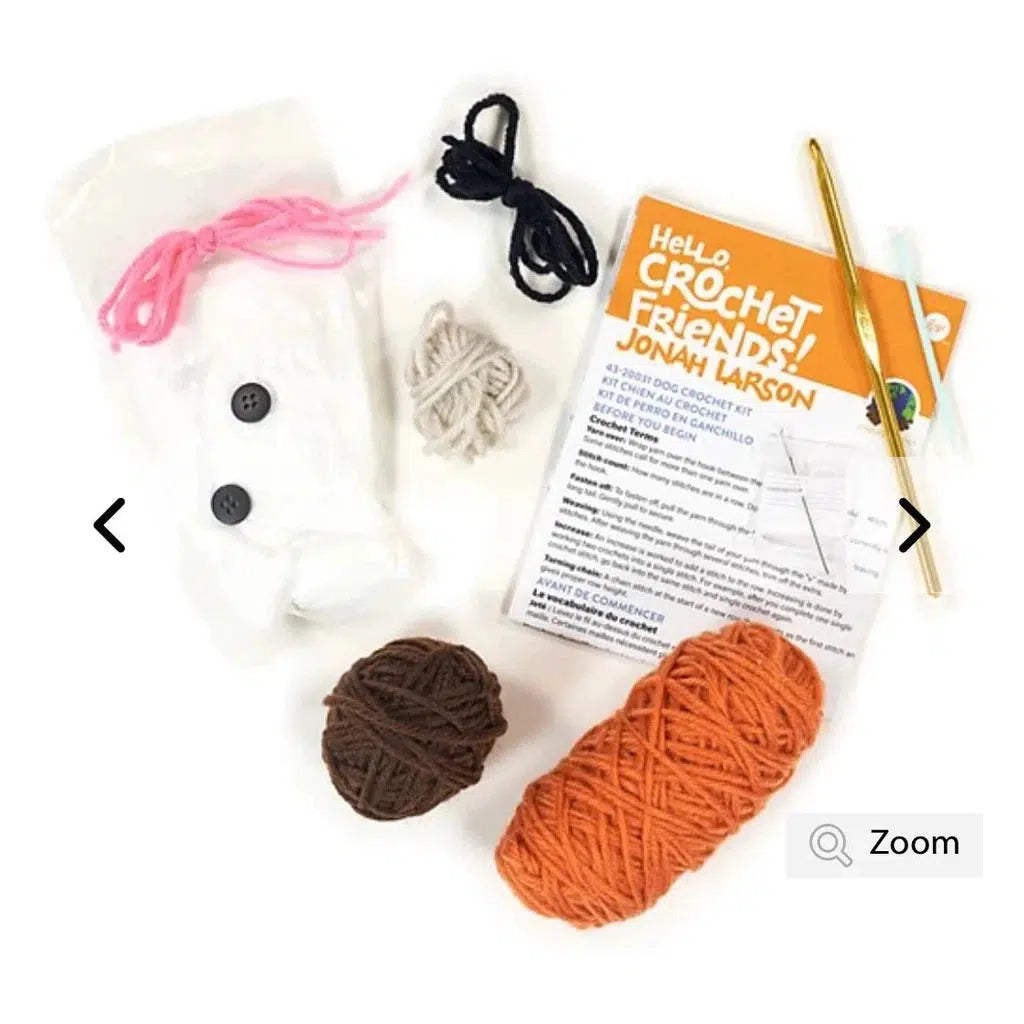 The components of the dog kit. Yarn, buttons, stuffing, needle and hook