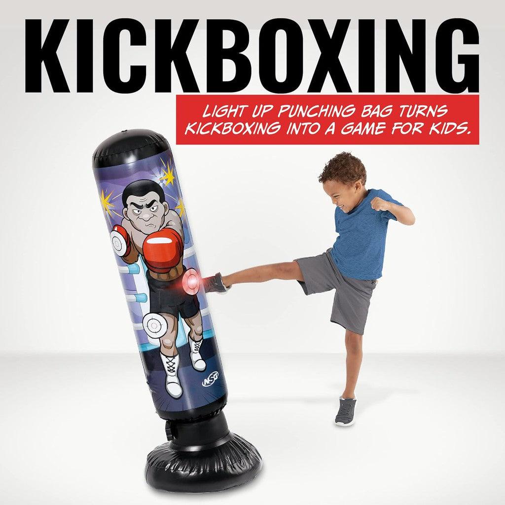 A child energetically kicks an LED lights punch bag designed for junior electronic kickboxing practice.