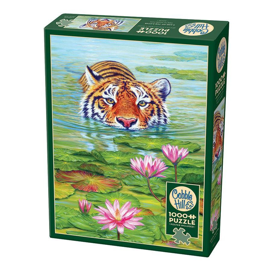 Puzzle box of 1000 pc puzzle featuring a tiger half submerged in a lake walking forward through lily pads