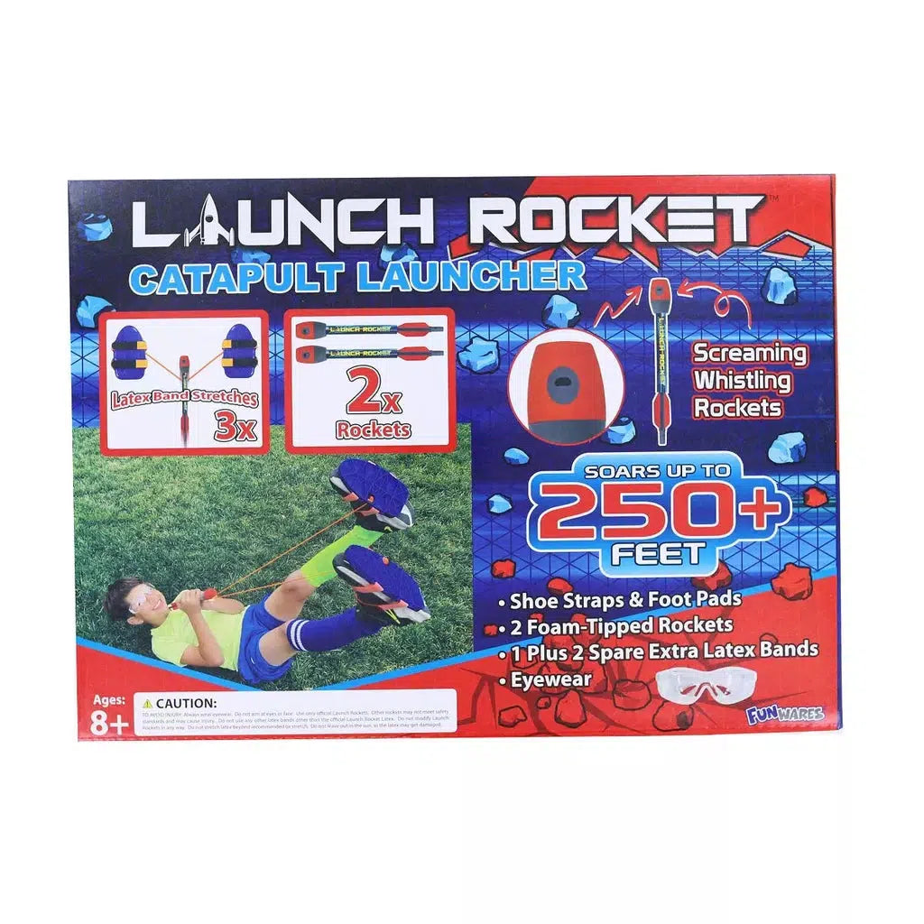 Packaging for the UT Brands Rocket Catapult Launcher showcases a child launching rockets, highlighting features like soaring over 250 feet. Accessories such as shoe straps and eyewear are included. 