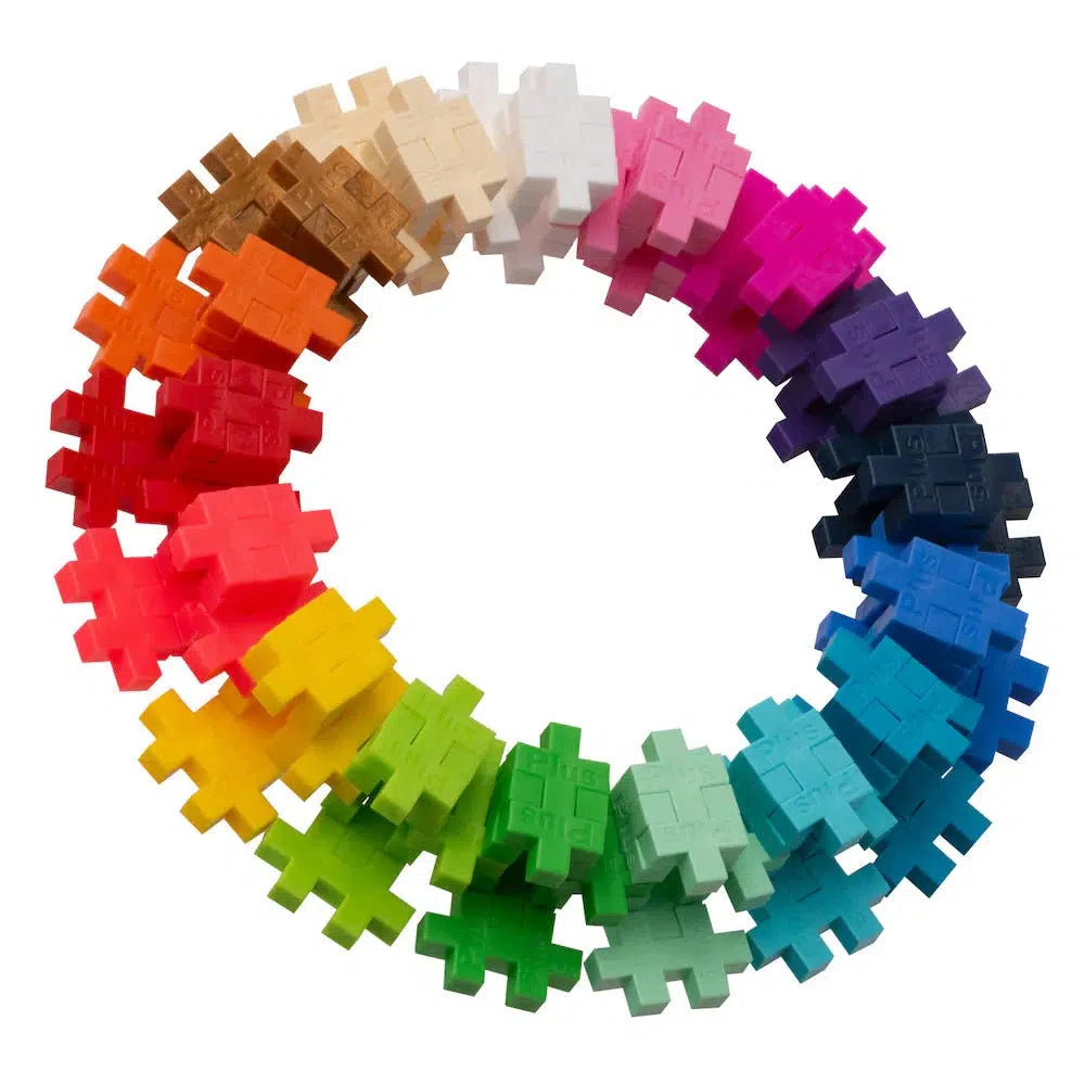 A circular arrangement of colorful, interlocking Plus-Plus puzzle pieces showcases shades like red, blue, green, yellow, and pink. This unique design highlights creativity in forming a harmonious pattern.