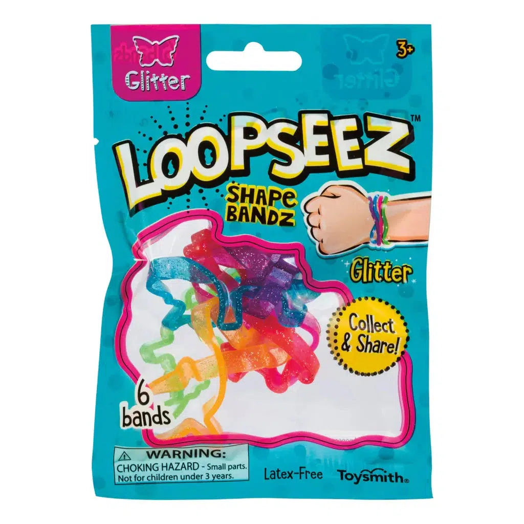 A package of colorful Loopseez wearable shape bands labeled "Glitter." Contains six collectible bands. Packaging mentions a choking hazard for children under three years old.