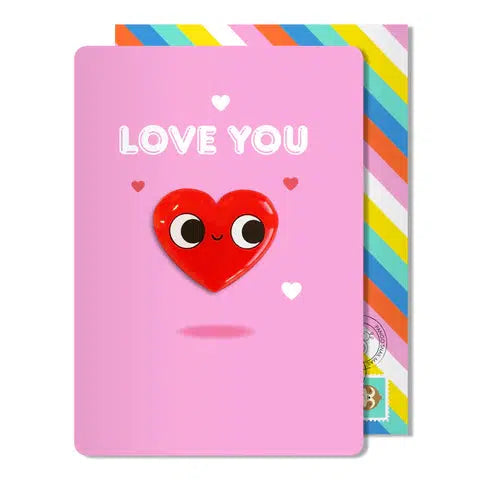 Pink card with magnet heart that says "love you". Comes with rainbow envelope