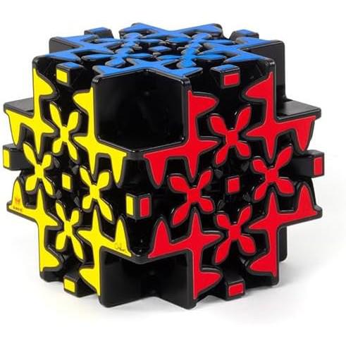 A complex, multicolored puzzle cube with yellow, red, and blue patterns on a black background features intricate, angular designs. This brainteaser puzzle's twisting gears resemble a Meffert's Maltese Gear masterpiece.